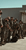 "Group of uniformed soldiers standing in formation outside hangar"